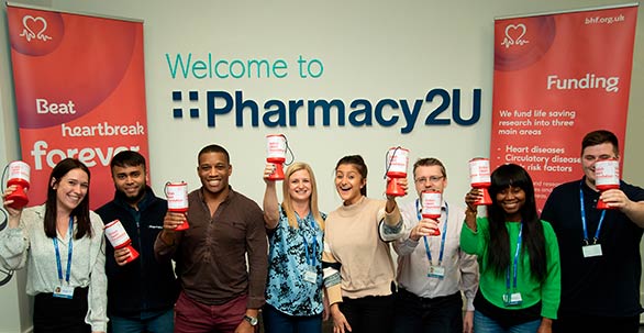 Pharmacy2U Staff holding charity collection tins
