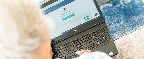 Older lady ordering her medication on her laptop